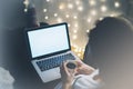 Girl in a chair in a homely atmosphere with an open laptop with a empty blank screen monitor and a cup of coffee or tea Royalty Free Stock Photo