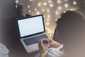 Girl in a chair in a homely atmosphere with an open laptop with a empty blank screen monitor and a cup of coffee or tea Royalty Free Stock Photo