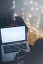 Girl in a chair in a homely atmosphere with an open laptop with a empty blank screen monitor and a cup of coffee or tea Royalty Free Stock Photo