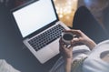 Girl in a chair in a homely atmosphere with an open laptop with a empty blank screen monitor and a cup of coffee or tea Royalty Free Stock Photo