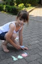 Girl chalking the street Royalty Free Stock Photo