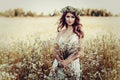Girl with chamomile wreath in field Royalty Free Stock Photo