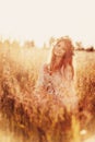 Girl with chamomile wreath in field Royalty Free Stock Photo