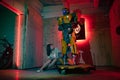 Girl Charlie Watson sits in garage near robot transformer Bumblebee