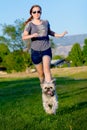 Girl chasing little dog