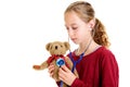 Girl check-up teddy bear with stethoscope Royalty Free Stock Photo