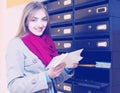 Girl checking correspondence at lobby Royalty Free Stock Photo