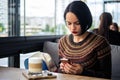 Girl checking mail while sitting in cafe Royalty Free Stock Photo