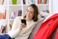 Girl checking smart phone messages in winter