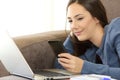 Girl checking smartphone message on a couch