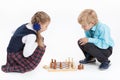 Girl checkmates boy, schoolchildren in uniform playing chess, isolated white background