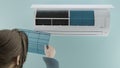 The girl checks the cleanliness of the filter in the air conditioner. 3d render