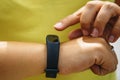 Girl checks pulse on fitness bracelet or activity tracker pedometer on wrist Royalty Free Stock Photo