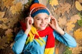 Girl cheerful face lay on wooden background with leaves top view. Fall and autumn season. Autumn melody concept. Hipster