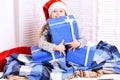 Girl with cheerful face sits on light window background