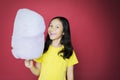 Girl cheering at cam while holding a cotton candy Royalty Free Stock Photo