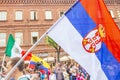a girl cheerleader holds the national flag of Serbia in the procession of football fans on Kuibyshev street at the carnival dedica