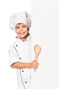 Girl chef with large spoon peeking from board Royalty Free Stock Photo