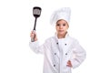 Girl chef white uniform isolated on white background. Holding black scapula up with another hand on the waist. Looking Royalty Free Stock Photo