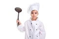 Girl chef white uniform isolated on white background. Holding black skimmer up. Looking at the camera. Landscape image Royalty Free Stock Photo