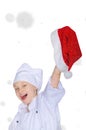 Girl in chef's costume and Santa hat on snow Royalty Free Stock Photo