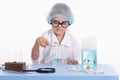 Girl Chemist pours liquid from a test tube into flask