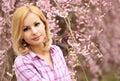 Girl with Cherry Blossom. Beautiful Blonde Young Woman Royalty Free Stock Photo