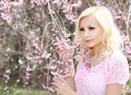 Girl with Cherry Blossom. Spring Flowers. Beautiful Blonde Woman Royalty Free Stock Photo