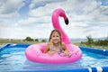 Girl child bathes in the pool Royalty Free Stock Photo