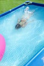 Girl child bathes in the pool Royalty Free Stock Photo