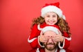 Girl child and bearded father wear santa costume. How to be santa claus parents guide. My dad is santa claus. Belief in