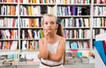 Girl child bemused a lot of books in bookstore