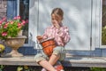 The girl child with a djembe drum outdoor on the porch of the house photo without processing