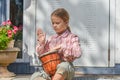The girl child with a djembe drum outdoor on the porch of the house photo without processing
