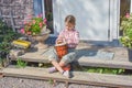 The girl child with a djembe drum outdoor on the porch of the house photo without processing