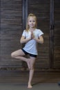 Girl child doing exercises doing yoga on a Mat in the Studio or at home