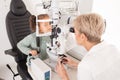 Girl child in eye exam for vision, woman optician checking kids eyes in consultation room and medical test. Healthcare Royalty Free Stock Photo