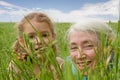 Girl child and grandmother together outside