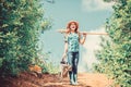 Girl child hold shovel watering can. Spring gardening checklist. Little helper. Watering tools that will solve dry yard Royalty Free Stock Photo