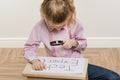 Girl child holding piece of paper with a word TECH EXPERT.