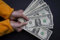 Girl child holds many American dollars paper money in her hands. Royalty Free Stock Photo