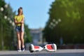 Girl child hurt her hand while falling from a hoverboard while riding in a park