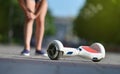 Girl child hurt her knee while falling off a hoverboard while riding in a park