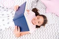 Girl child lay bed read book top view. Encourage useful habits.Kid prepare to go to bed. Pleasant time in cozy bedroom Royalty Free Stock Photo