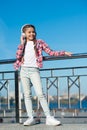 Girl child listen music outdoors with modern headphones. Kids headphones tested and ranked best to worst. Enjoy sound