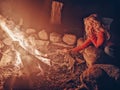 Girl child making smores roasted marshmallows in fire on campsite at night. Popular american children activity Royalty Free Stock Photo