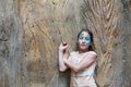 Girl child outdoors near tree with butterfly face painting Royalty Free Stock Photo