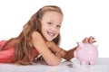 Girl child, piggy bank and coins for portrait, studio and pride with smile for investing by white background. Kid