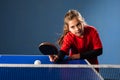 Girl child plays ping pong on indoor