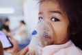 Girl child is receiving a doctor`s medication smoke to cure asthma, a lot of phlegm. There is a chance that the child will be